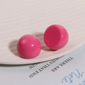 Detailed view of glossy hot pink resin round beads on a white textured ceramic tray - Rose Red