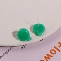 Close-up of green resin round earrings with hanging loops and silver needles - Green
