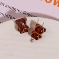 Macro detail of amber brown glass bear beads with gold outlines and metal pins - 1 Piece / Brown