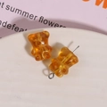 Close-up of amber translucent bear-shaped resin beads for DIY jewelry making - 1 Piece / Yellow
