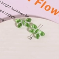 Detailed macro shot of translucent green glass butterfly pendant for DIY jewelry making - Light Green with White Thread