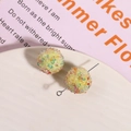 Macro shot of colorful sugar ball resin beads with glitter for DIY jewelry making - Yellow