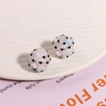 Macro shot of sugar-coated heart beads with colorful dots on a cream wave tray - 1 Piece / White