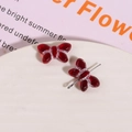 Close-up of red Czech glass bow beads with frosted edges for DIY jewelry making - Red with White Thread