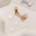 Detailed view of golden screw-on earring converters with clear silicone comfort pads - Gold (With Hanging Loop)