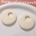 Macro detail of 50mm cream-white resin hollow round pendants for DIY jewelry making - Off White