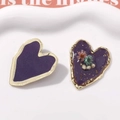Detailed close-up of handmade heart earrings with purple enamel and real dried flowers - L Purple