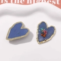 Close-up of heart-shaped blue enamel and dried flower alloy jewelry pendants - L Blue