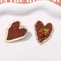 Close-up of asymmetric heart stud earrings with red enamel and gold foil inlay - Large Size Brown