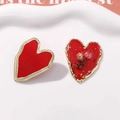 Macro detail of red enamel heart earring with gold edges and embedded dried flowers - Large Size Red