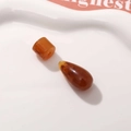 Macro shot of amber resin beads and water drop pendants with marble texture detail - Amber Waterdrop And Cylinder Style