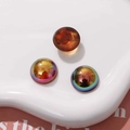 Close-up of amber and iridescent geometric resin cabochons for DIY jewelry making - Round