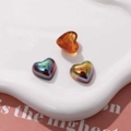 Close-up of three colorful geometric heart resin patches on a decorative plate - Heart