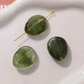 Macro view of olive green marble texture resin drop beads with gold metal pin for DIY jewelry - 1 Piece / Green