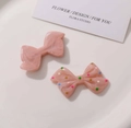 Detail of colorful polka dot and pink marble resin bow charms for DIY craft jewelry - Solid Pink