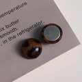 Close-up of leopard print fabric round charms with flat silver metal base for DIY jewelry - Coffee Round