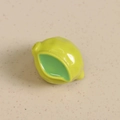Macro shot of 3D green resin lemon charm with pre-drilled hole for DIY jewelry making - Lime