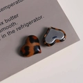 Detailed macro view of heart-shaped leopard print charms with flat silver metal back - Coffee Heart