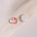Macro shot of iridescent and pearl white heart-shaped charms on champagne silk fabric - Water Ripple Heart (10*8mm)