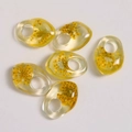Handmade clear resin pendants with yellow dried flowers and organic pebble shapes - Ginger Yellow