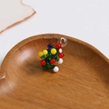 Macro detail of a 3D glass Christmas tree charm with colorful dots on a wooden tray - Christmas Tree Style (1PC Style No. 2)