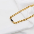 Golden Cuban chain necklace with a rectangular black pendant on white silk fabric - Black Mother of Pearl Necklace (DG-XL00195) / Gold