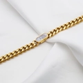 Golden Cuban link bracelet featuring a white marble oval shell inlay on wrinkled fabric - White Mother of Pearl Bracelet (DG-SL00019) / Gold