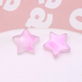Macro detail of pink gradient star resin charms with glitter for DIY craft jewelry making - 1 Piece / Purple