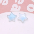 Macro detail of star-shaped resin charms with glitter gradient for DIY jewelry making - 1 Piece / Blue