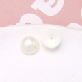 Macro view of cream white half-round faux pearls with flat backs for DIY jewelry making - 1 Piece/Pack / White