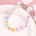 Detailed macro view of colorful macaron heart beads and white pearls on a shoe chain - Heart Style
