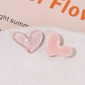 Close-up of glittery light pink heart resin flatback charms for DIY hair accessories - Pink