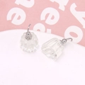 Detail of transparent jelly-style acrylic earrings with pleated texture and silver hooks - White
