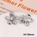 Macro detail of silver floral shoe charms with pink rhinestone and textured metal finish - Pink Rhinestone Flower Type A