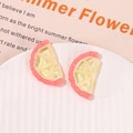 Close-up of pink and yellow resin lemon slices for DIY jewelry and phone cases - Pink
