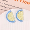 Detailed close-up of DIY resin lemon slice charms in yellow and blue for jewelry making - Blue