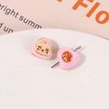 Detailed close-up of pink enamel Daruma and Fu character charms for jewelry making - Pink Cartoon Star Clip (My Melody)