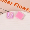 Detailed macro shot of pink glitter resin square charms for DIY earring and jewelry making - Pink