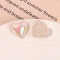 Macro shot of colorful pearlescent resin heart charms with aurora finish for DIY jewelry - Iridescent White Heart Style