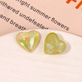 Macro detail of yellow resin heart charms with iridescent coating and glitter texture - Iridescent Yellow Heart Style