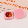 Detailed macro view of pink resin square earrings with amber marble circular inlays - Light Pink