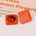 Detail of square orange resin earrings with amber center inlay for DIY jewelry making - Orange