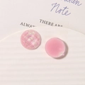 Close-up of geometric round resin charms with pink glitter and matte finishes for DIY jewelry - Pink