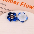 Detailed macro view showing the front and back of aurora coral sequin flower accessories - Dark Blue