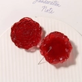 Macro view of 3D red resin rose beads with metal eyelets for DIY jewelry making - Red
