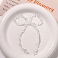Close-up of transparent beaded crystal bow accessory for DIY handmade jewelry crafts - White