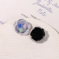 Macro detail of mixed-color resin rose charms with unique glitter texture and flat back - Black Base Pink Blue Green