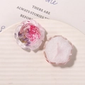 Macro detail of resin rose charms showing embedded dried pink flowers and glitter back - Pink