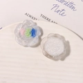 Macro shot of 3D resin rose charms with glitter and gradient colors for DIY jewelry - White Base Pink Blue Green