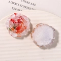 Detailed macro view of resin rose charms with embedded dried flowers for DIY hair clips - Red